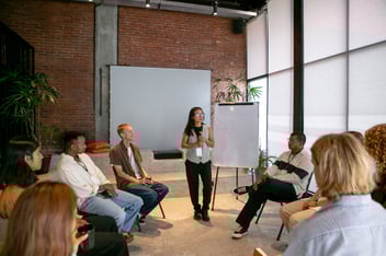 Woman facilitating a room of people
